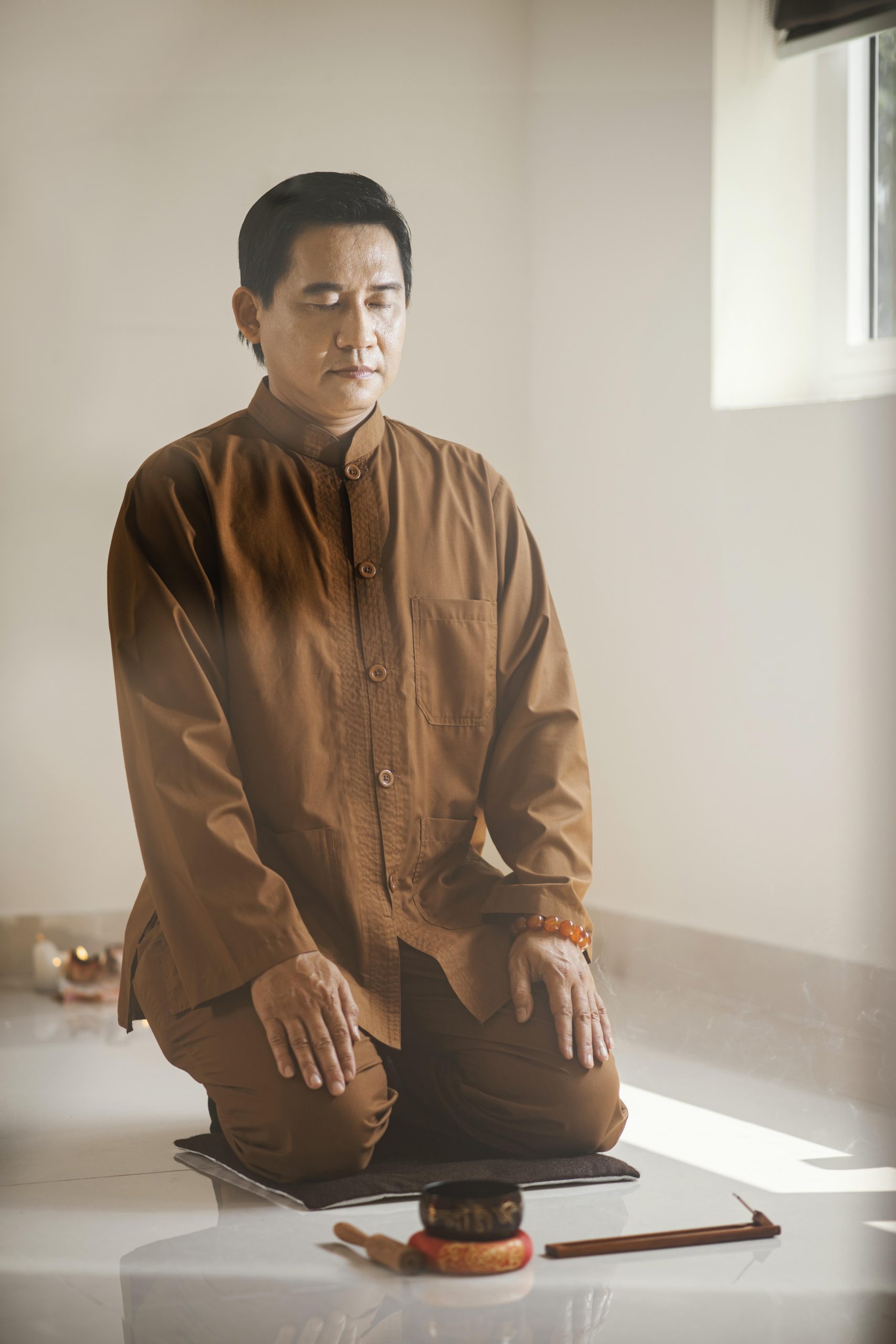 man meditating with singing bowl incense